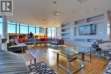 Vancouver apartment for rent - A living room with a glass coffee table and a television.