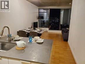 Vancouver apartment for rent - A modern kitchen with a dining table set for two.