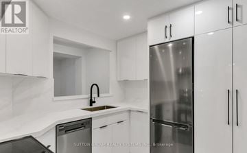 Toronto (Church-Yonge Corridor) condo for rent - A modern kitchen with white cabinets and stainless steel appliances.
