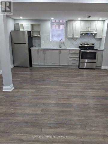 Mississauga (East Credit) apartment for rent - A kitchen with a stainless steel refrigerator, oven, and cabinets.
