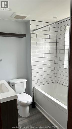 Windsor apartment for rent - A white toilet sits next to a white sink in a bathroom.