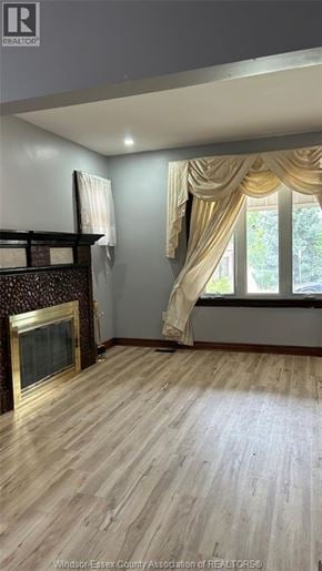 Windsor apartment for rent - A room with a fireplace and a window with curtains.