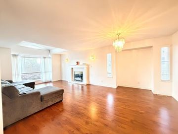 Surrey apartment for rent - A living room with a grey couch and a fireplace.