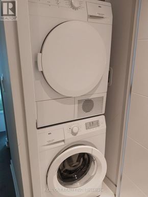 Toronto (University) condo for rent - A white washing machine and dryer stacked on top of each other.