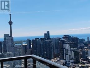 Toronto (University) condo for rent - A cityscape with the CN Tower in the background.