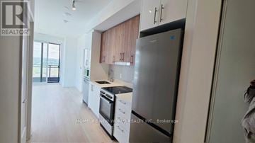 Markham (Greensborough) condo for rent - A modern kitchen with a refrigerator, oven, and sink.