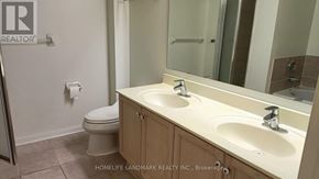 Markham (Unionville) townhouse for rent - A bathroom with a toilet, sink and mirror.