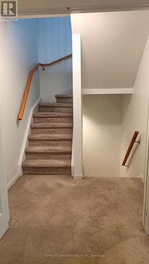 Markham (Unionville) townhouse for rent - A staircase with a carpeted runner and wooden handrails.