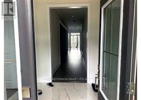 Caledon (Caledon East) apartment for rent - A hallway with a glass door and a sign that says "Empire Realty".