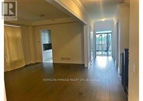 Caledon (Caledon East) apartment for rent - A spacious room with wooden flooring and a large window.