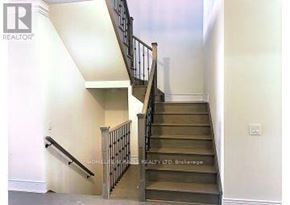 Caledon (Caledon East) apartment for rent - A staircase with a metal railing and wooden steps.