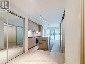 Toronto (Waterfront Communities) condo for rent - A modern kitchen with wooden floors and a large island.