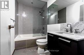 Toronto (Church-Yonge Corridor) condo for rent - A bathroom with a marble countertop and a glass shower stall.