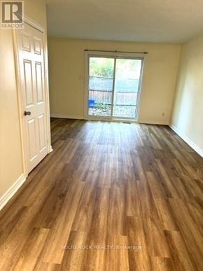 Ottawa townhouse for rent - A room with wooden flooring and a sliding glass door.