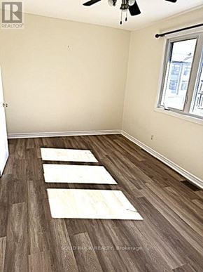 Ottawa townhouse for rent - A room with a window and a ceiling fan.