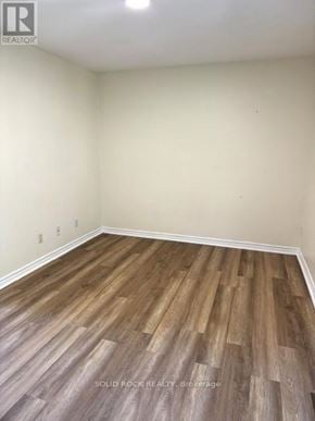 Ottawa townhouse for rent - A room with wooden flooring and a white wall.