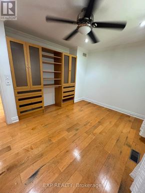Oakville (Wo West) apartment for rent - A room with wooden floors and a ceiling fan.