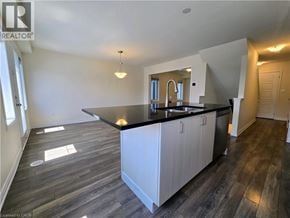 Cambridge townhouse for rent - A kitchen with a black countertop and white cabinets.