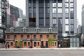 Toronto (Bay Street Corridor) condo for rent - A building with the sign 8 Wellesley in front of it.