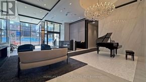 Toronto (Bay Street Corridor) condo for rent - A living room with a piano and a chandelier.