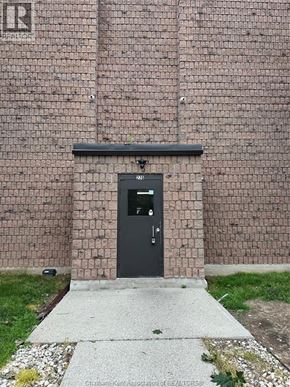 Chatham condo for rent - A brick wall with a black door and a small window above it.
