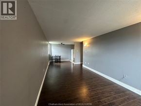 Chatham condo for rent - A room with wooden flooring and a dining table in the corner.