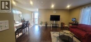 Windsor apartment for rent - A living room with a red couch and a flat screen TV.