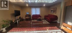 Windsor apartment for rent - A living room with a red couch and a television.