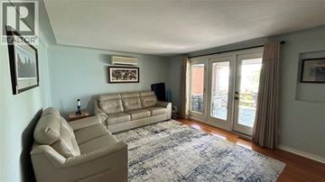 Sombra apartment for rent - A living room with a beige couch and a blue rug.