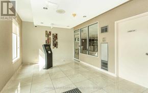 Mississauga (Cooksville) condo for rent - A hallway with a brokerage sign on the wall.