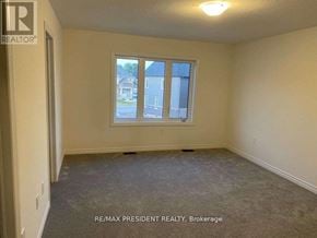 Brantford apartment for rent - A room with a window showing a view of a house across the street.