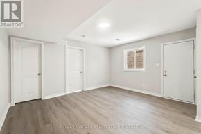 Welland (Dain City) apartment for rent - A spacious room with white doors and a window with blinds.