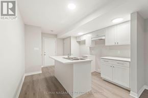 Welland (Dain City) apartment for rent - A white kitchen with a sink and cabinets.