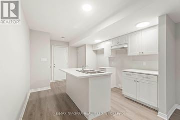 Welland (Dain City) apartment for rent - A white kitchen with a sink and cabinets.