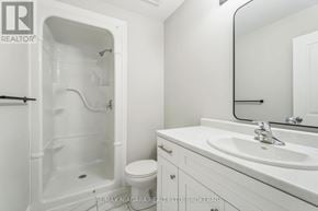 Welland (Dain City) apartment for rent - A white bathroom with a toilet, sink, and shower.