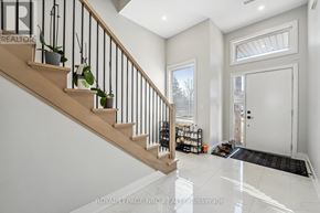 Welland (N. Welland) apartment for rent - A well-lit foyer with a staircase and a door leading to another room.