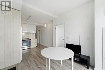 Toronto (Henry Farm) condo for rent - A modern living room with a white table and a television.
