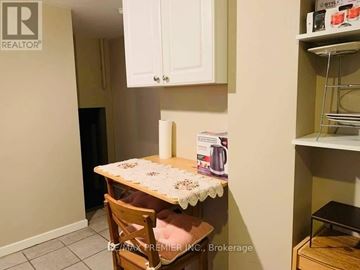 Toronto (Islington-City Centre West) duplex for rent - A small kitchen with a table and a chair.