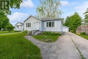 St. Catharines (Fairview) apartment for rent - A house with a grey roof and a white garage door is for sale.