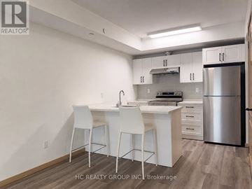 Toronto (L'amoreaux) townhouse for rent - A kitchen with white chairs and a stainless steel refrigerator.