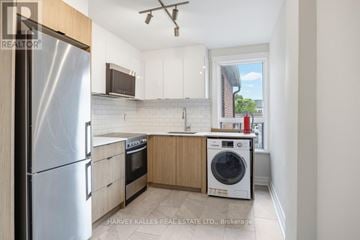 Toronto (Dovercourt-Wallace Emerson-Junction) apartment for rent - A kitchen with a refrigerator, oven, and washing machine.