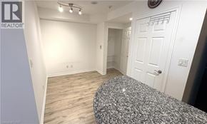Toronto condo for rent - A bedroom with a bed, dresser, and a door.