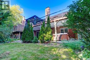 Pickering (Liverpool) apartment for rent - A house with a red door and a balcony surrounded by trees.