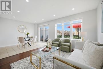 Brampton (Northwest Brampton) townhouse for rent - A living room with a glass table and a white couch.