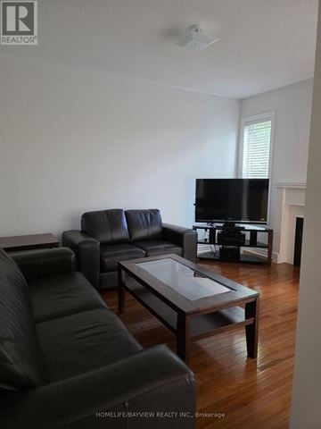 Richmond Hill (Westbrook) apartment for rent - A living room with a black leather couch and a glass coffee table.