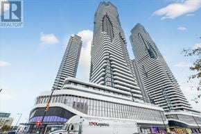 Vaughan (Vaughan Corporate Centre) condo for rent - A tall building with a curved facade and a sign that reads "XPOLCHICAGO" is in the foreground.