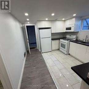 Mississauga (Streetsville) apartment for rent - A kitchen with white cabinets and a black countertop.