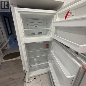 Mississauga (Streetsville) apartment for rent - A white refrigerator with the door open and shelves inside.