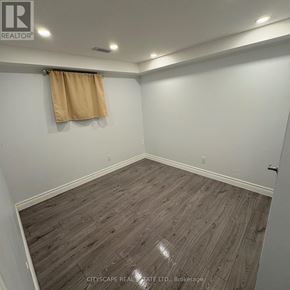 Mississauga (Streetsville) apartment for rent - A room with wooden flooring and a tan curtain.