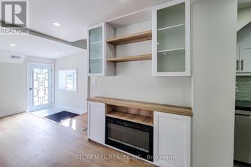 Woodstock (Woodstock - South) apartment for rent - A modern kitchen with white cabinets and a microwave oven.